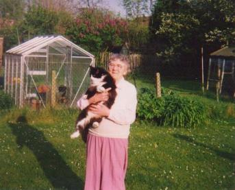 Gladys at home with one of her cats.
