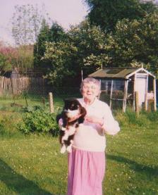 Gladys at home with one of her cats.